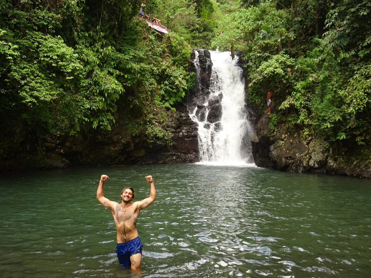 Man jumping into waterfall