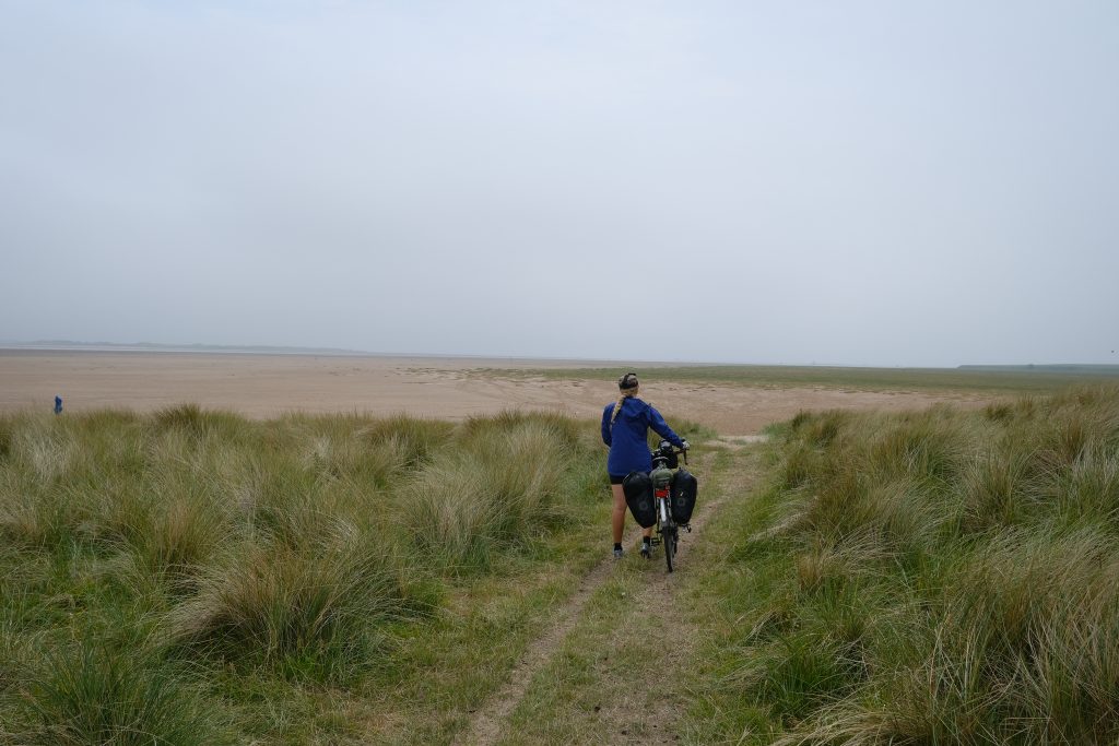 Girl cycling by the seaside