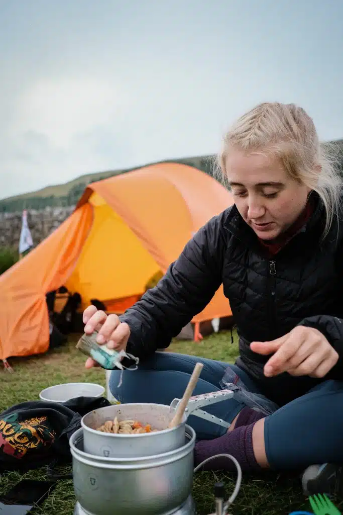 Girl cooking bikepacking meal