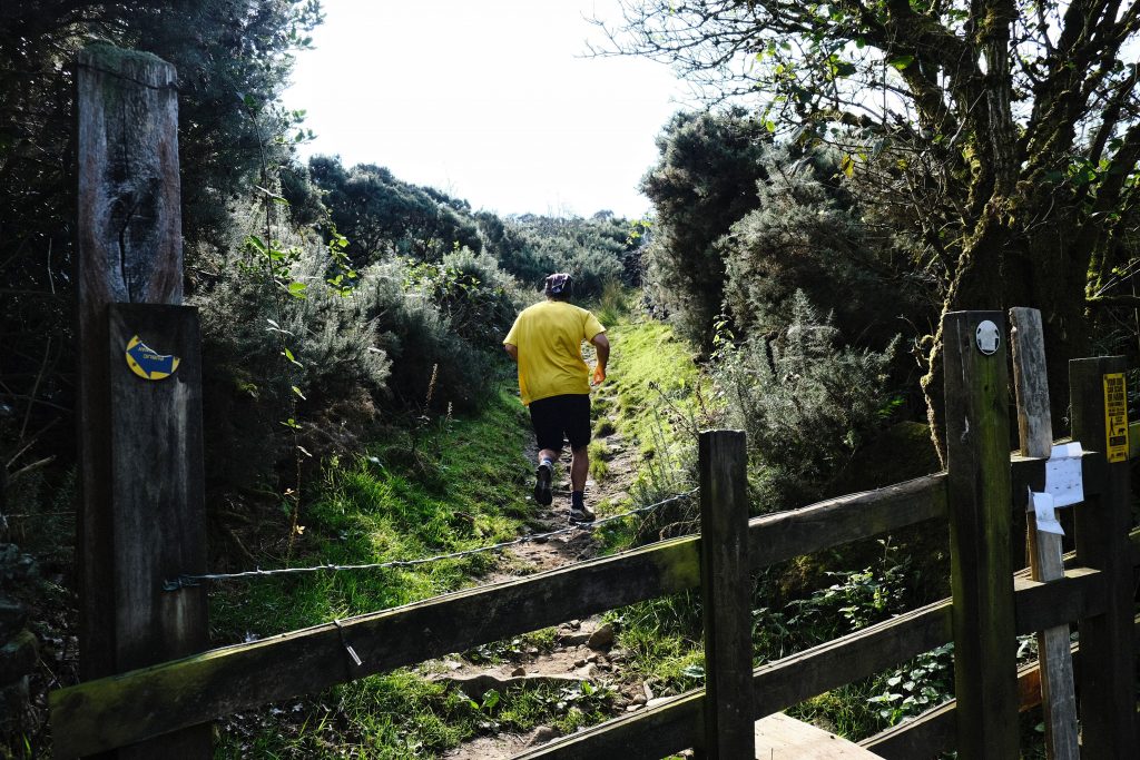 Vegan runner running up a hill