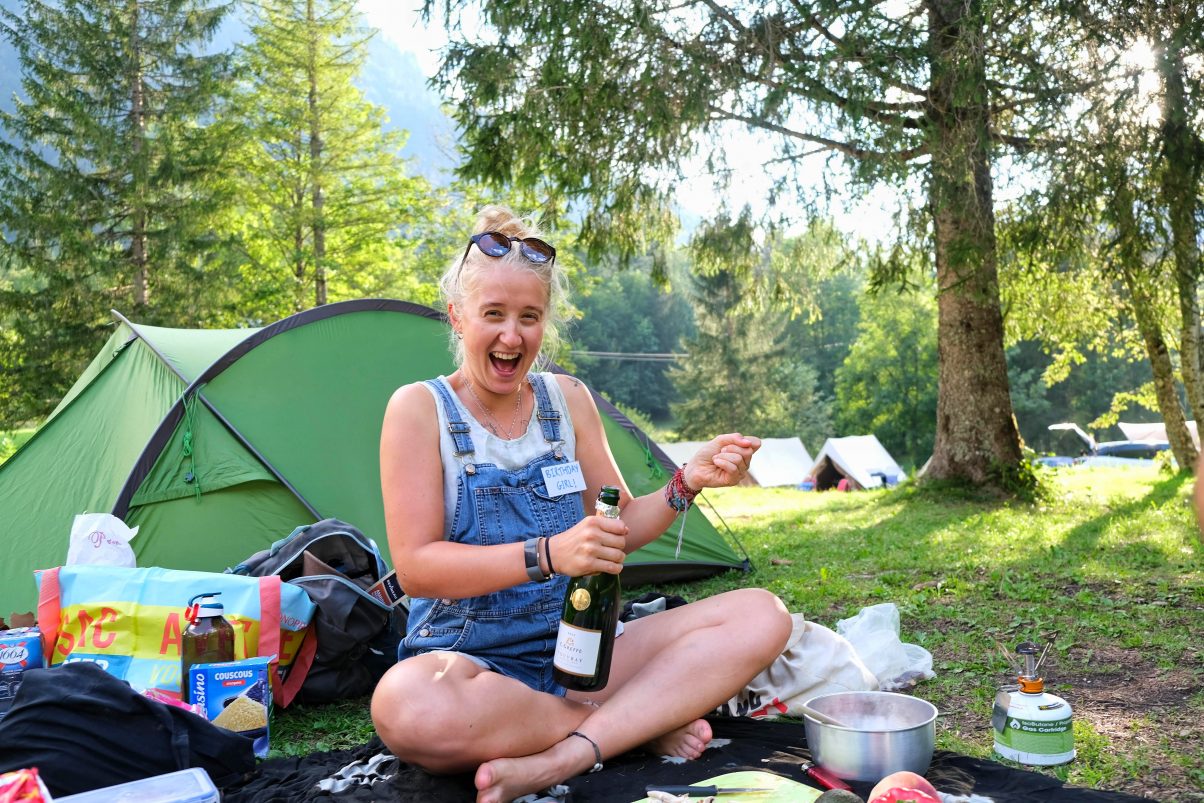 Girl popping champagne in the forest