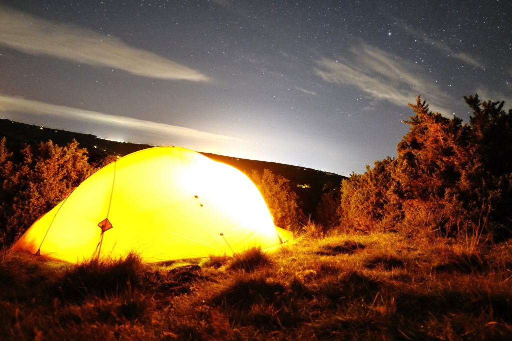 Tent at night under starry sky