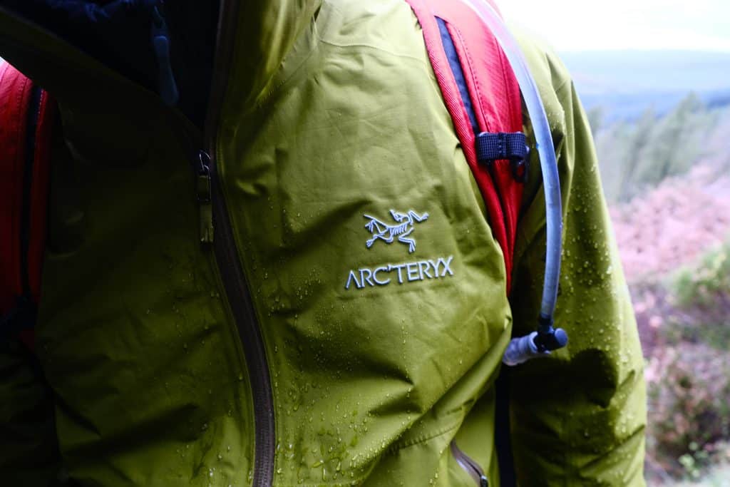Man wearing waterproof hiking clothes (Arc'teryx rain jacket)
