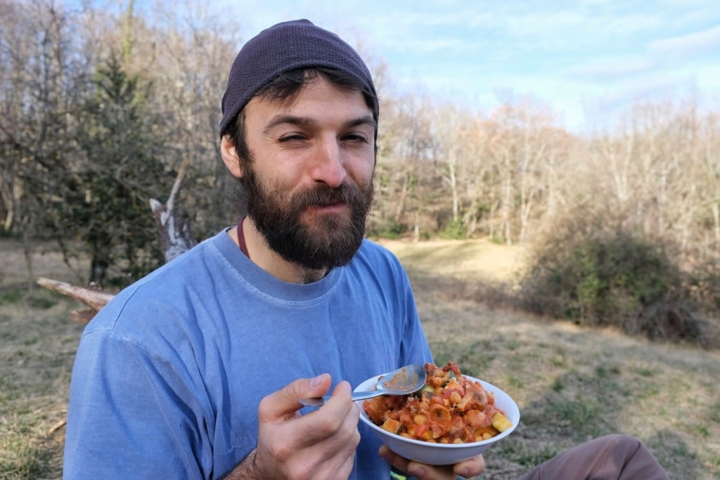 Man eating vegan campfire food 