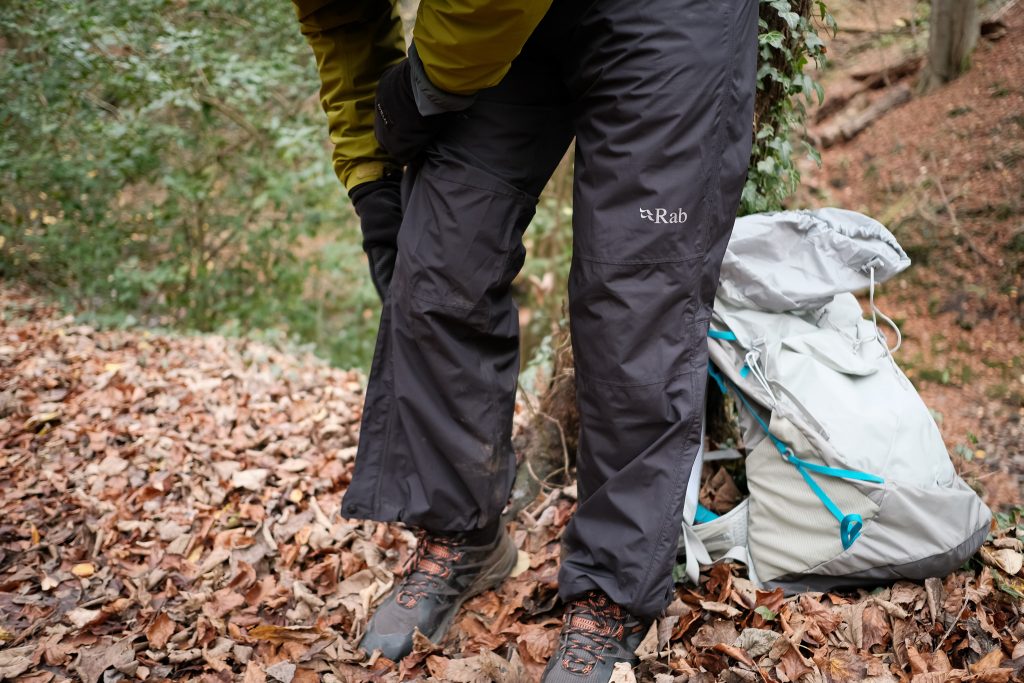 Zipping up Rab Eco rain pants