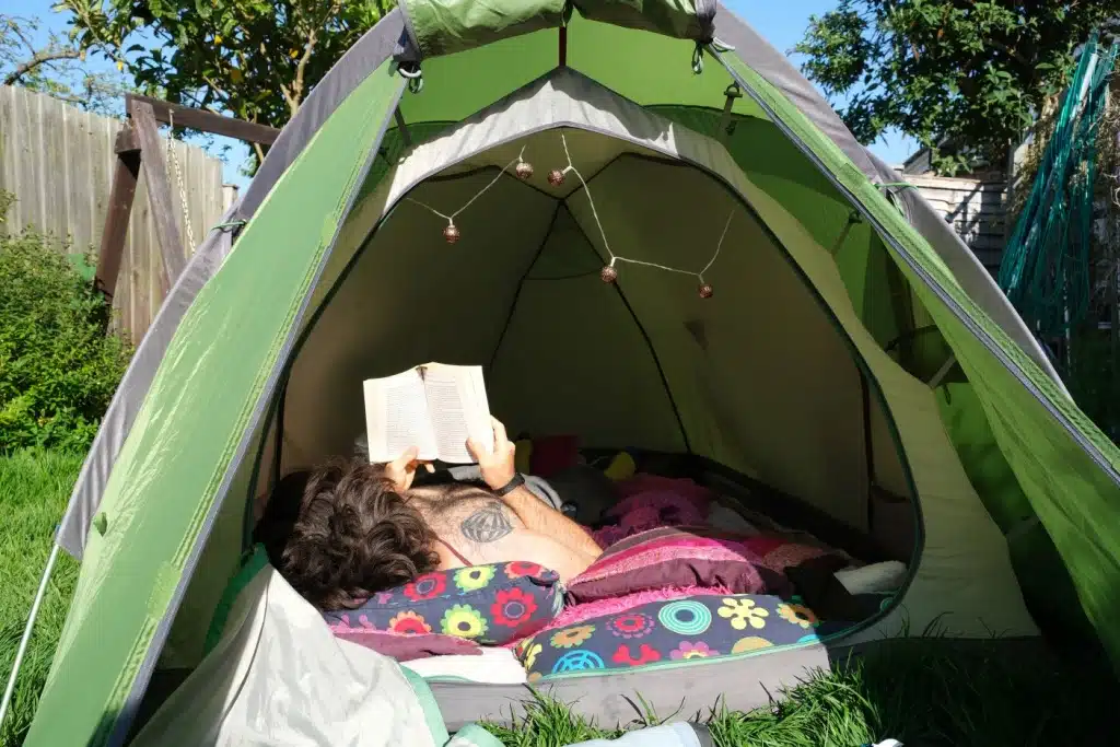Man camping in his back garden