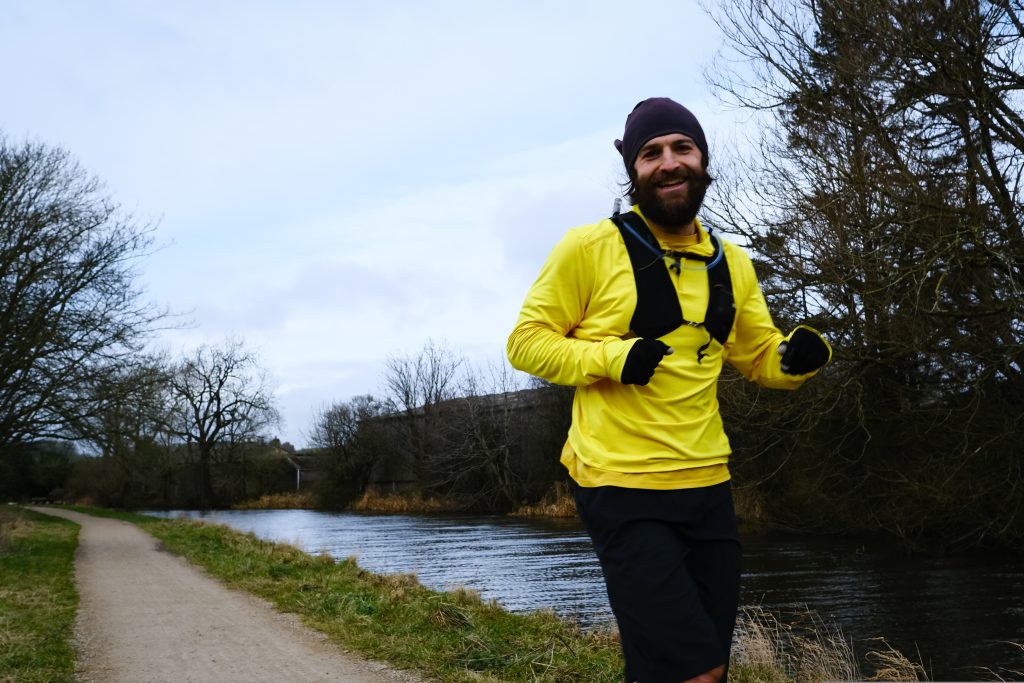 Man running along a canal path