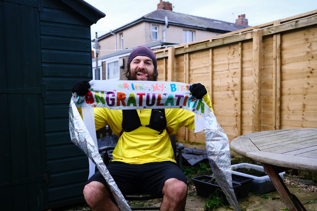 Man holding birthday banner