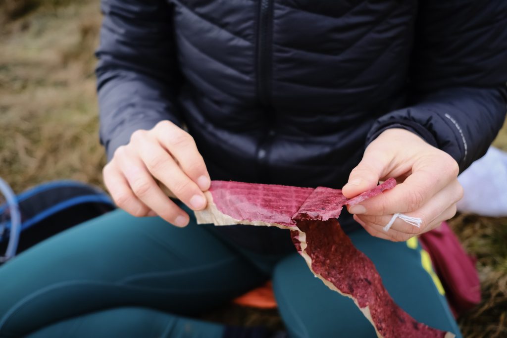 Eating berry fruit leathers outside 