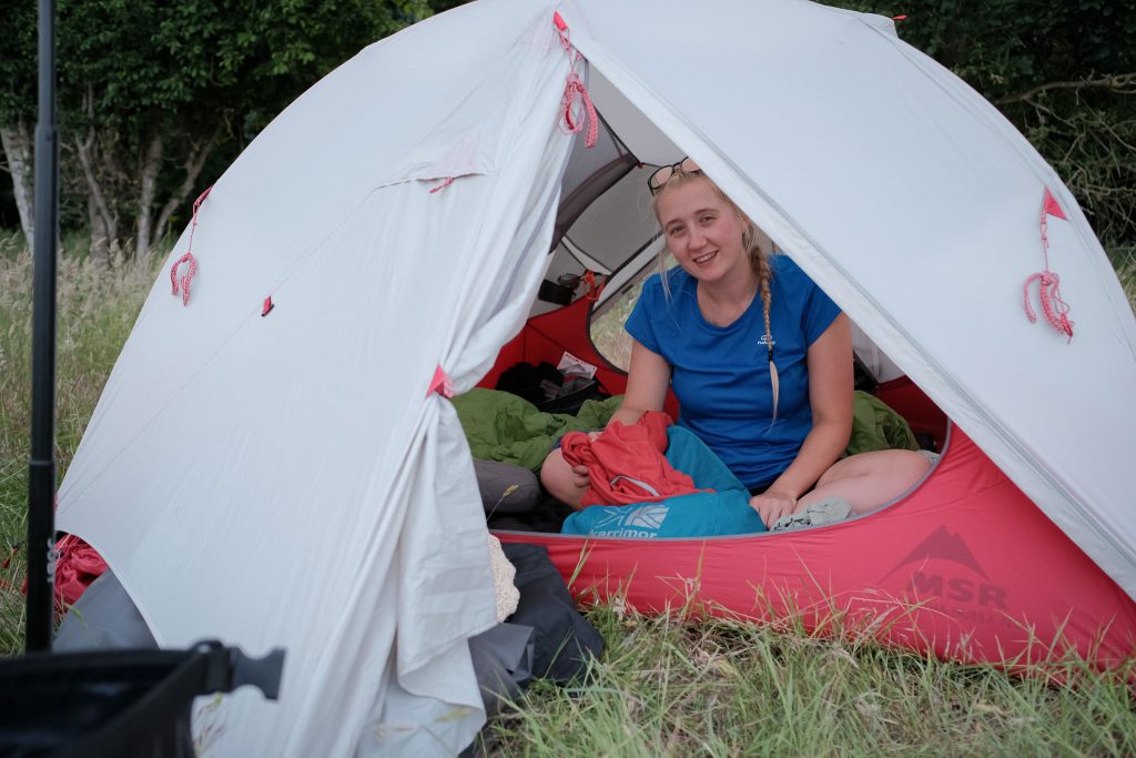 Girl in tent with vegan camping clothing