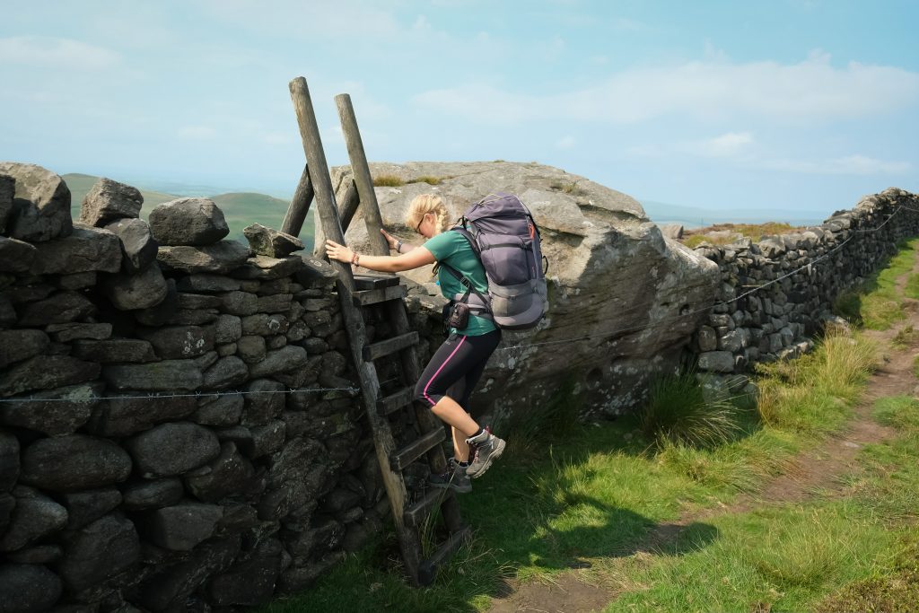 Women hiking over turnstyle