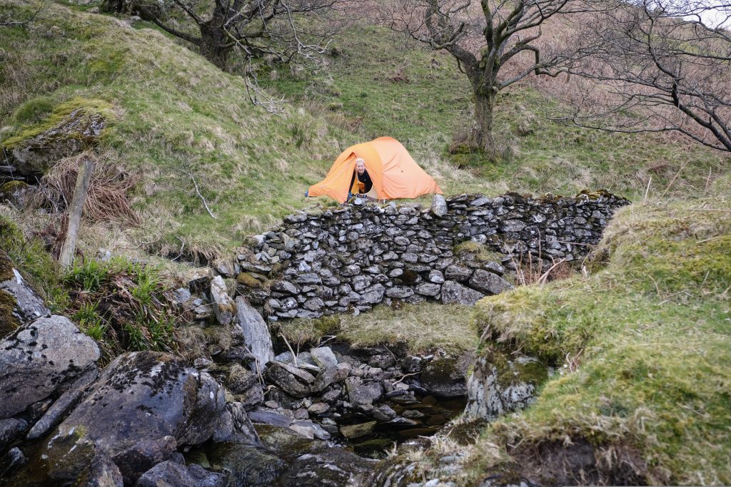 Girl poking head out fo tent