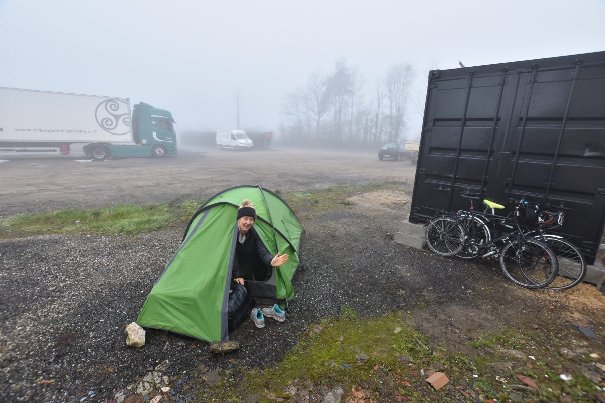 Girl camping in carpark