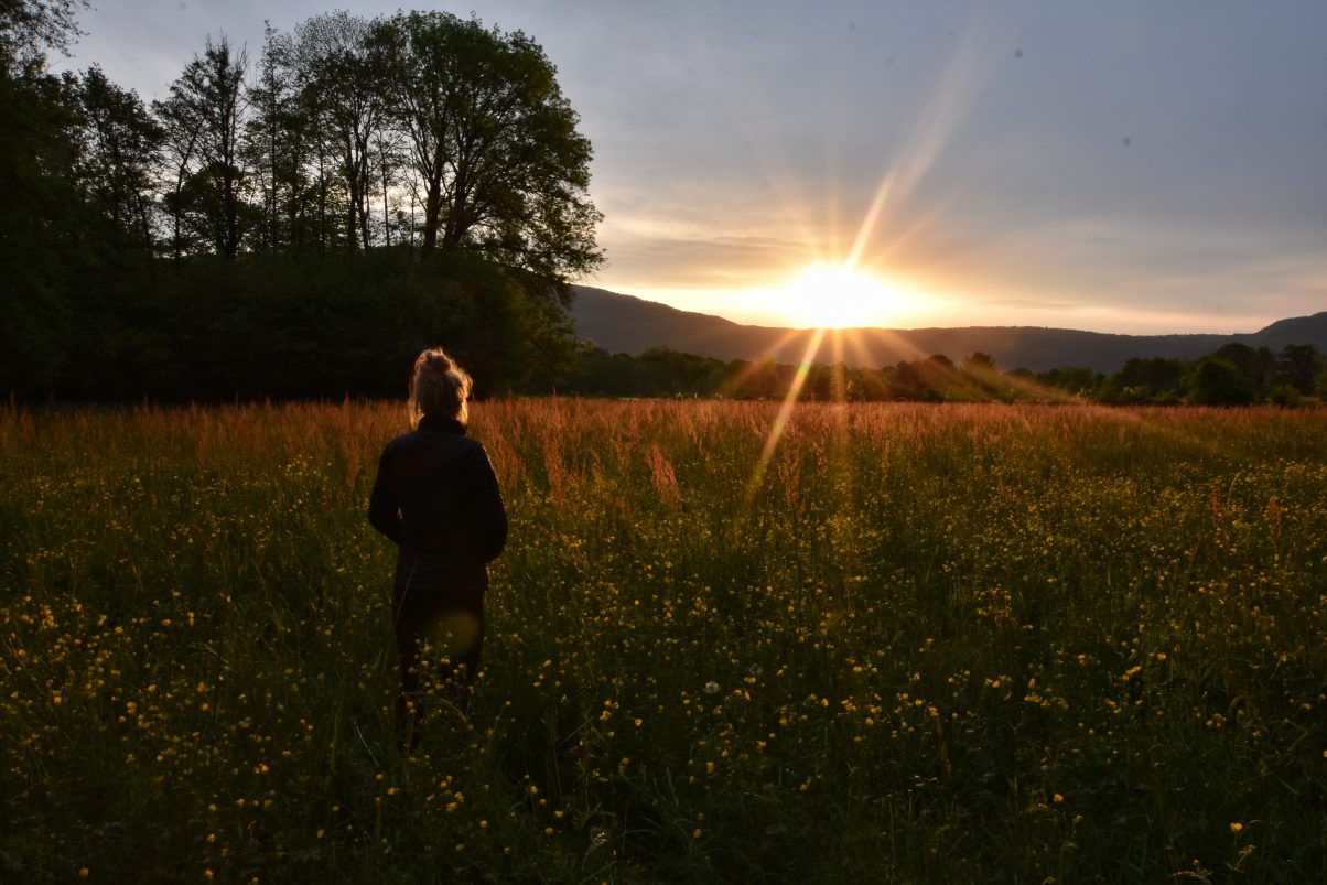 Girl in field sunrise