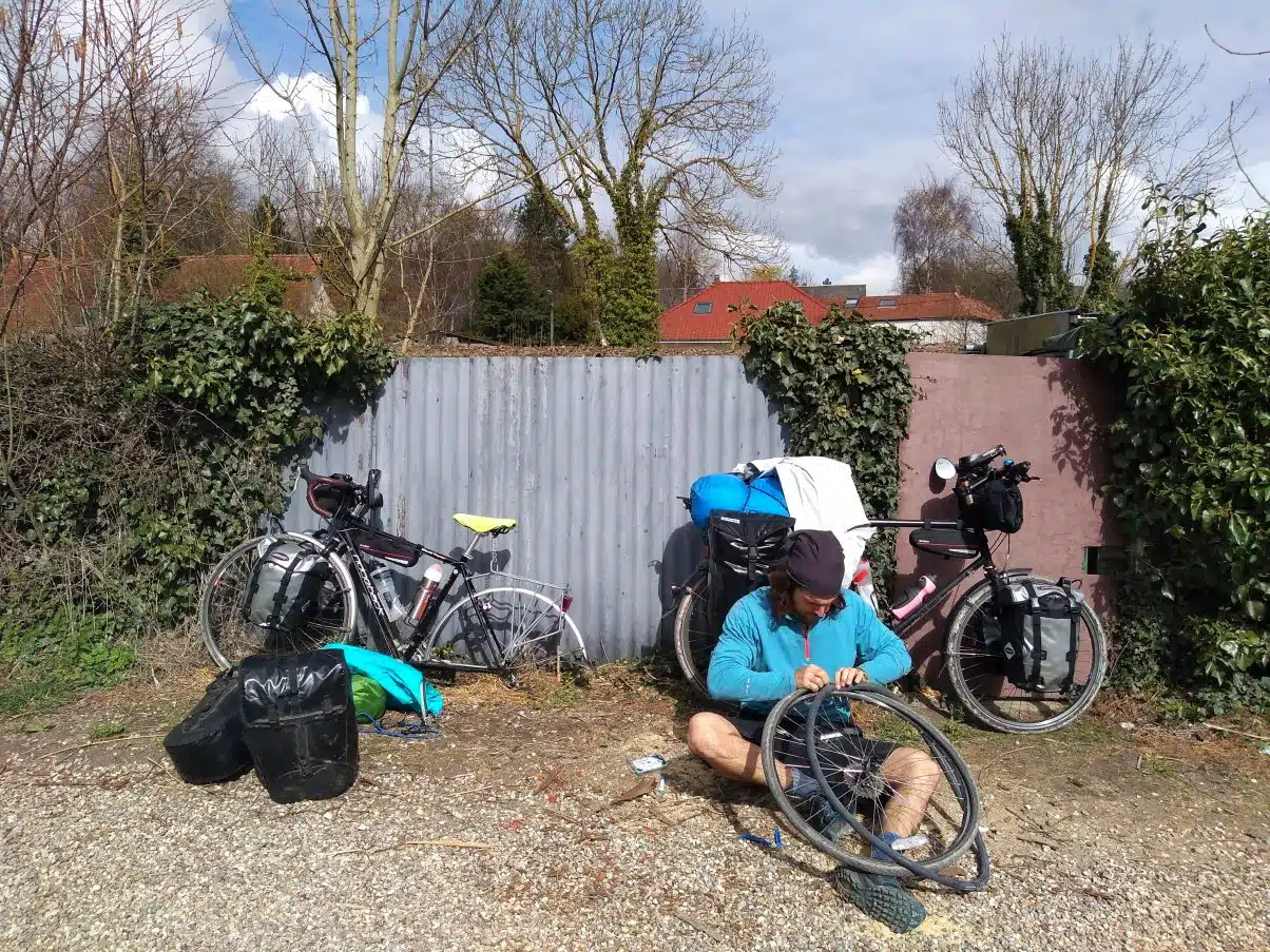 Man fixing a bicycle puncture with tool kit