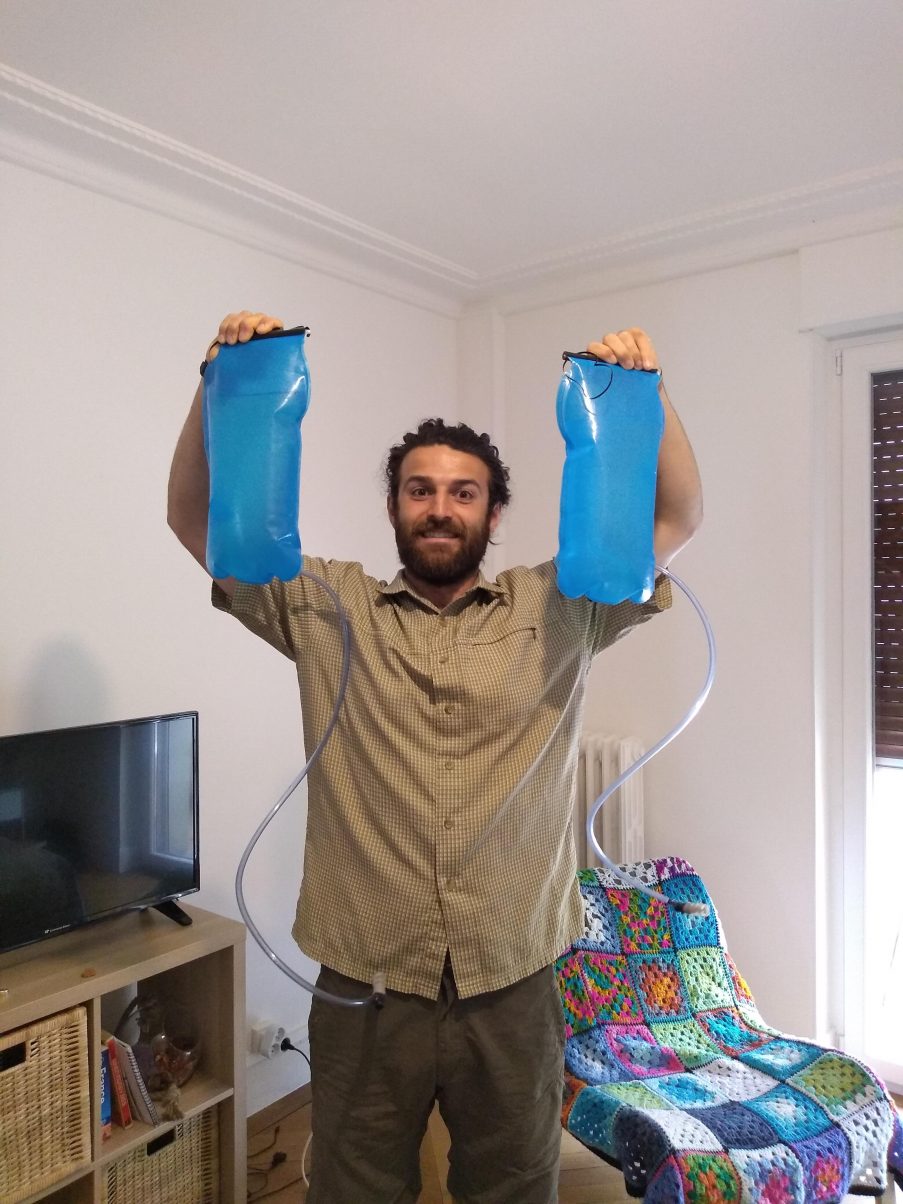 Hiking man carrying water bladders