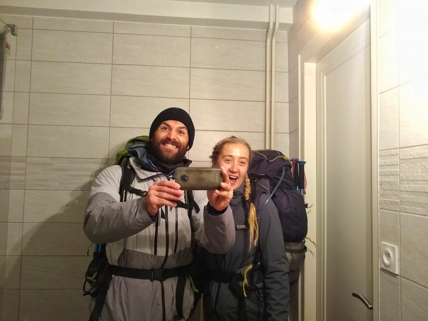 Hiking couple in mirror reflection