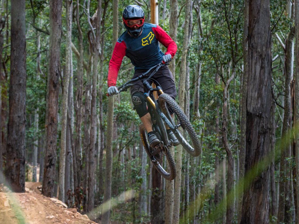 Mountain biker in air from dirt jump