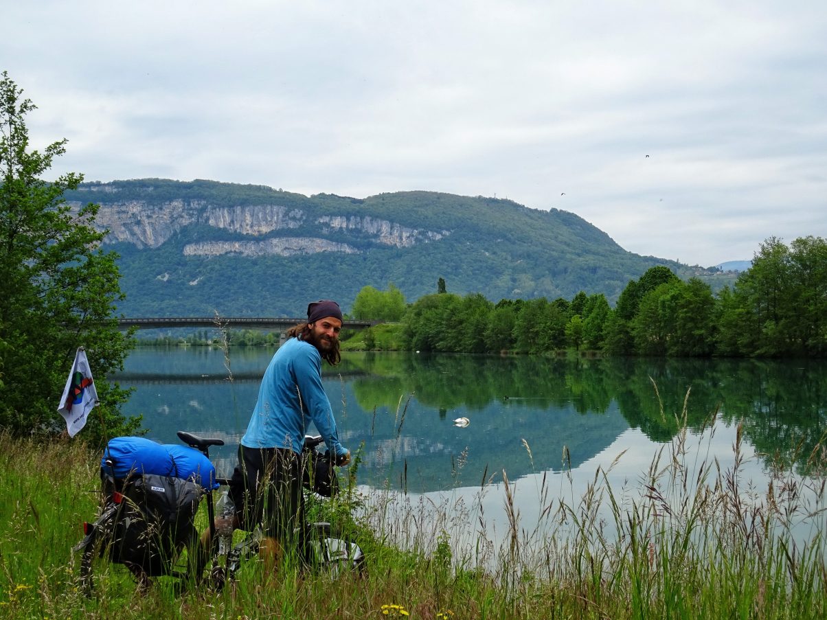 Man bike touring in front of rover