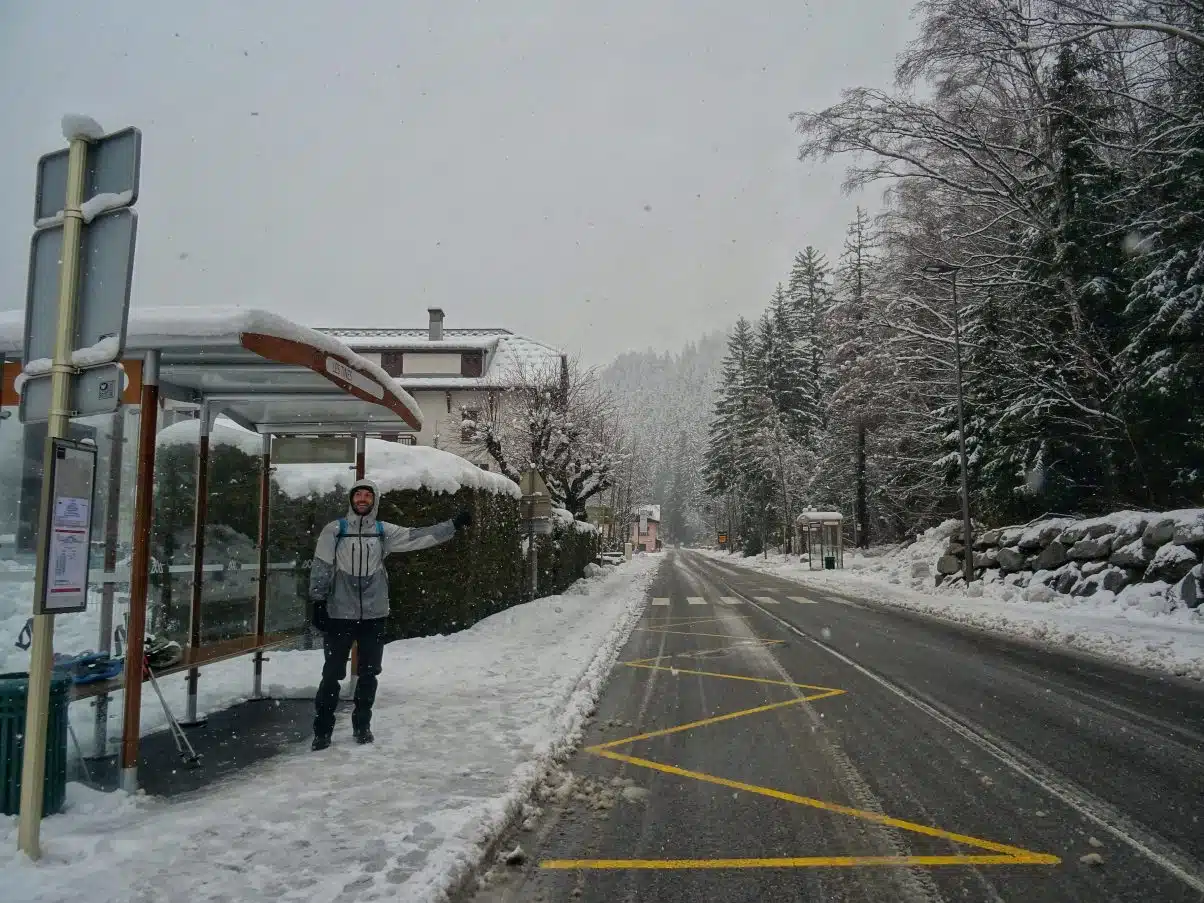 Man at bus stop in snow 