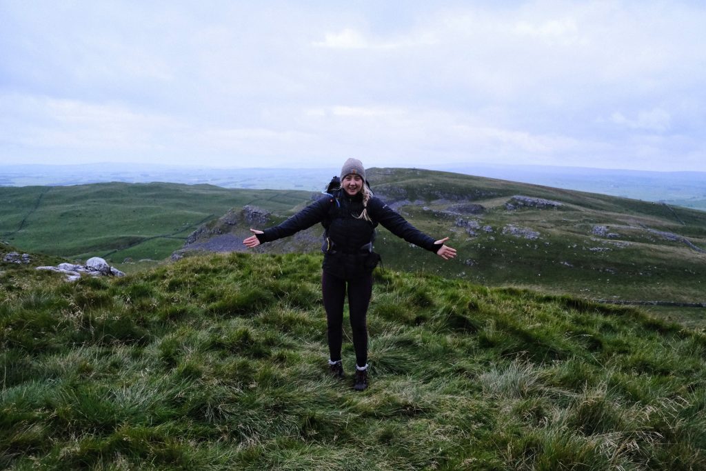 Girl standing in front of leave no trace wild camping spot 