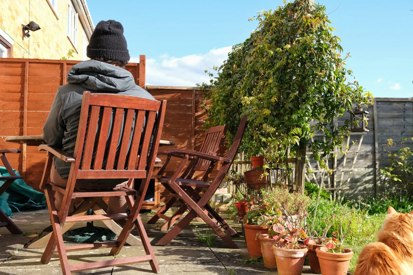 Man sitting in garden on sunny day 