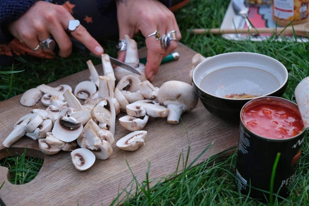 Girl chopping mushrooms for peanut curry