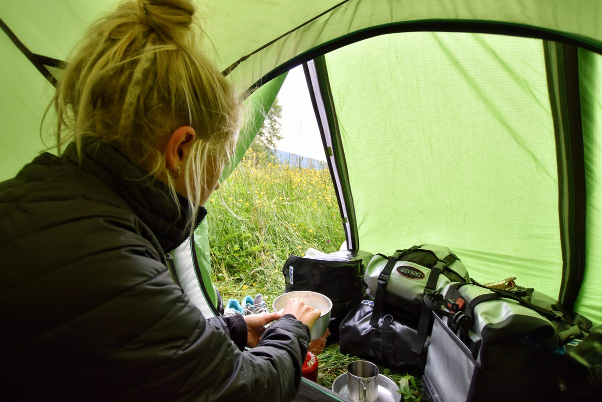 Girl cooking on camp stove 