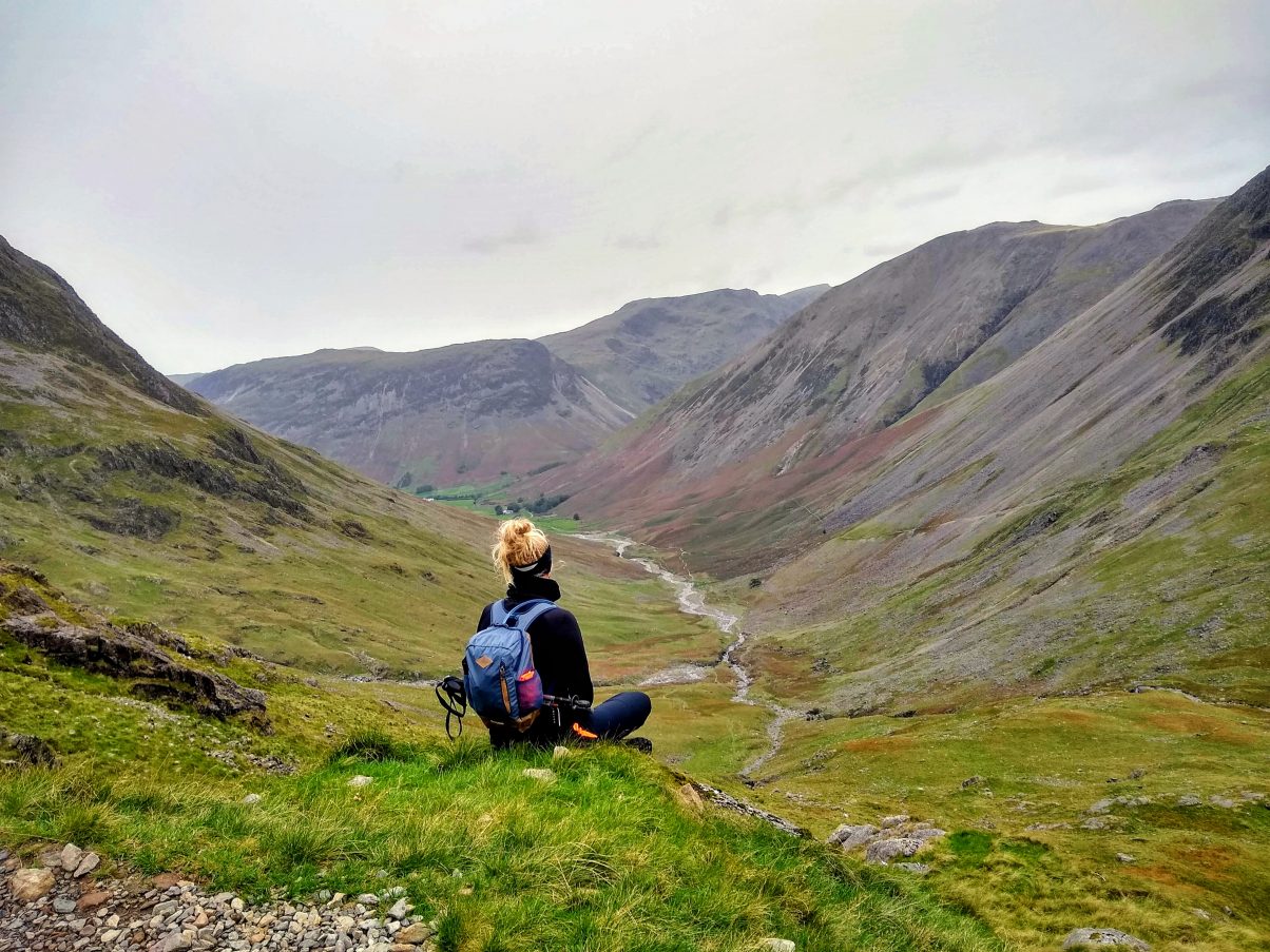 Girl on mountain eating vegan hiking food