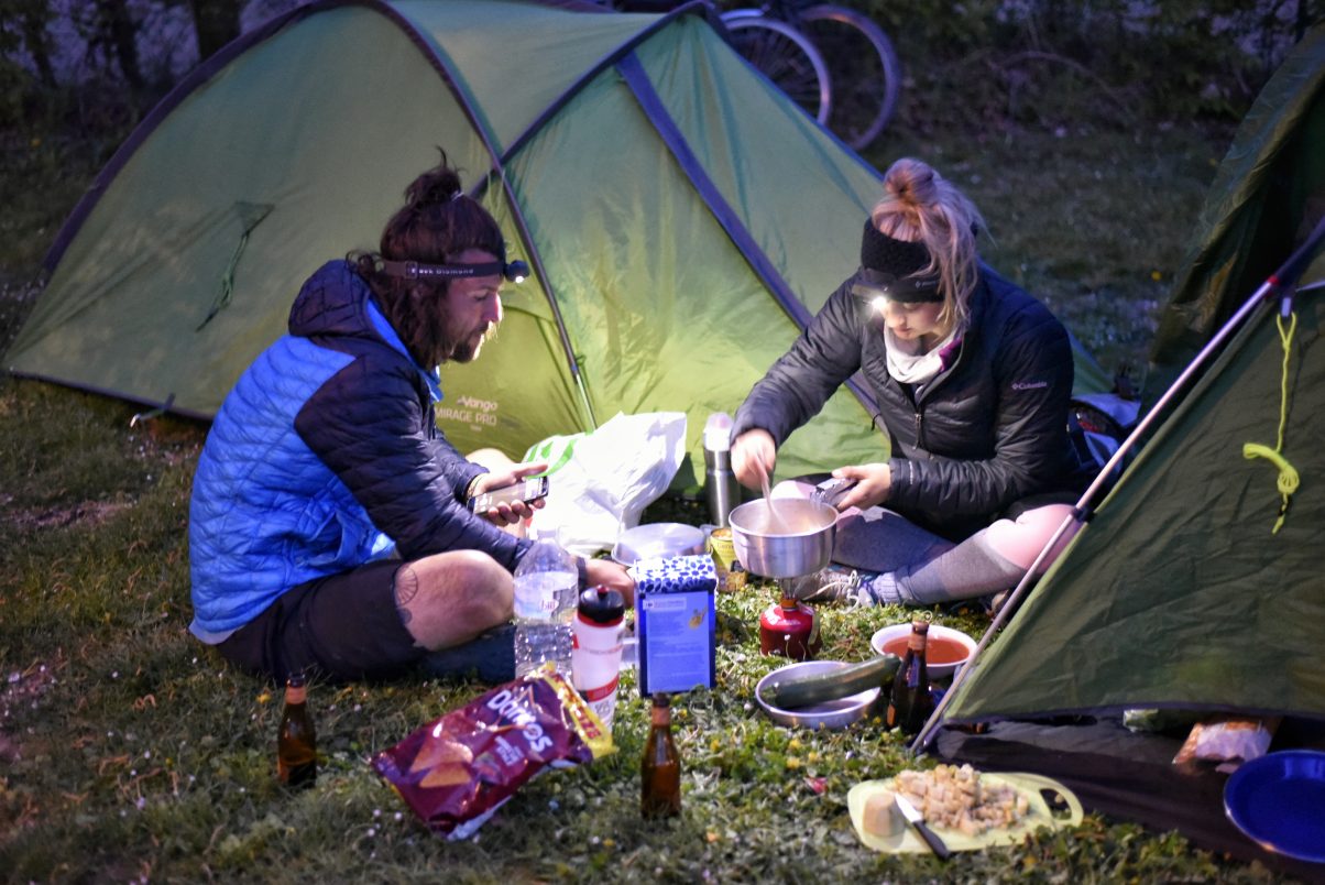 Two campers cooking on camp stove 